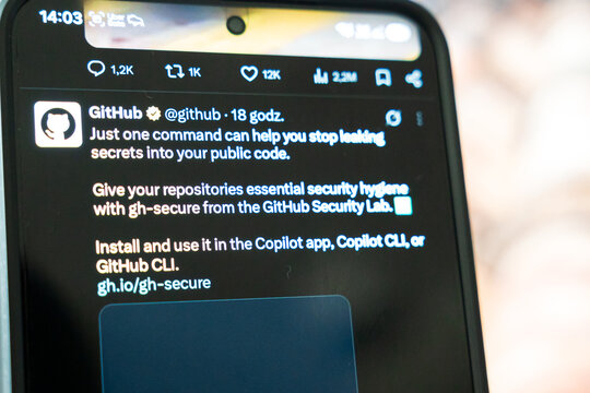 Warsaw, Poland - Oct 2, 2026: GitHub post on X promoting gh-secure from the Security Lab, one command to stop leaking secrets into public code, smartphone screen also naming the Copilot app, Copilot 