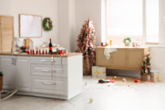 Christmas party aftermath, messy kitchen interior with holiday decorations and festive clutter after a celebration in a home living space