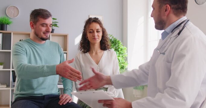 Doctor, visiting couple at home, explain medical records, filling patient information file, talking to husband and wife, giving optimistic consultation on planning pregnancy, test results recommend