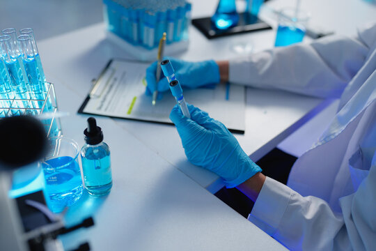 Scientist conducting research, analyzing samples in laboratory