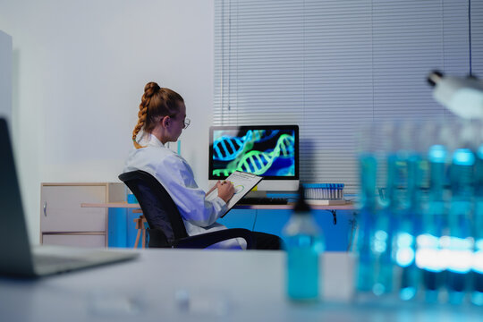 Scientist analyzing dna helix structure in modern laboratory
