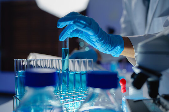 Scientist hand holding test tube in laboratory