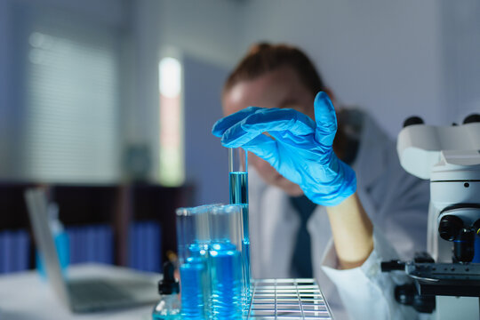 Scientist in lab holding test tube for research