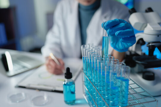 Scientist holding test tube doing medical research in laboratory