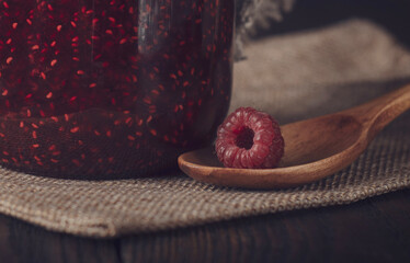 Raspberry jam with fresh raspberry on wooden spoon © Oleksandr