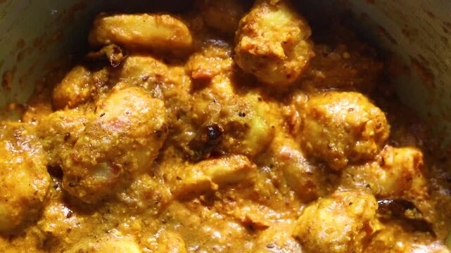 Arbi/Taro root  ki sabji made with curd and Indian spices  with gravy on a pan 