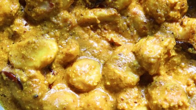 Arbi/Taro root  ki sabji made with curd and Indian spices  with gravy on a pan 