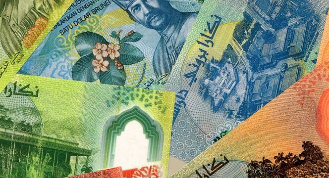 Brunei Darussalam dollar money bills in pile on table. Brunei BND currency cash close up
