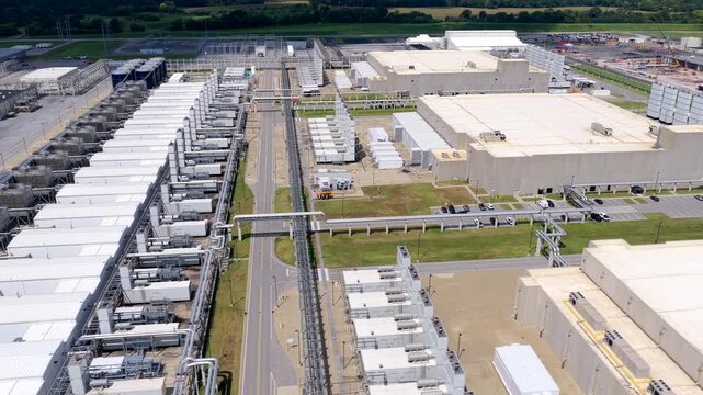 Data Center layout of multiple buildings, extensive rows of mechanical equipment, utility infrastructure and connecting roads across the facility, aerial view