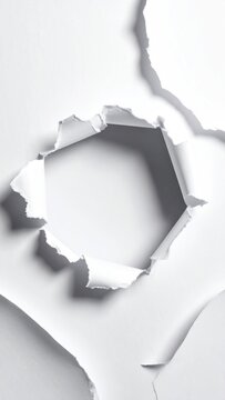 White paper ripped open with jagged edges, revealing a bright, empty space