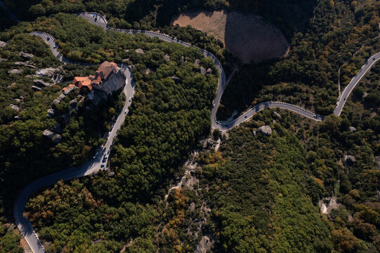 Winding mountain road through forest near Meteora Greece