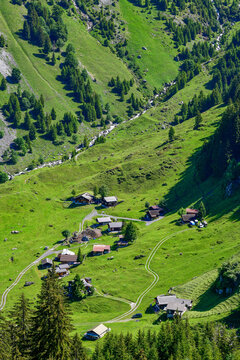 Die idyllische Alp &Auml;sch mit traditionellen Alph&uuml;tten am Fu&szlig;e einer imposanten Felswand im Sch&auml;chental, Kanton Uri, Schweiz