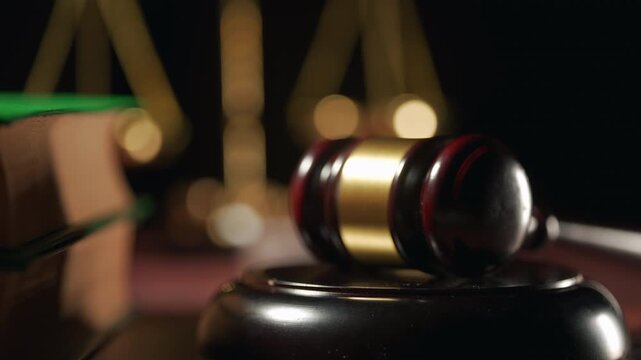 Wooden gavel beside golden scales of justice. Law firm, court trial and legal advice
