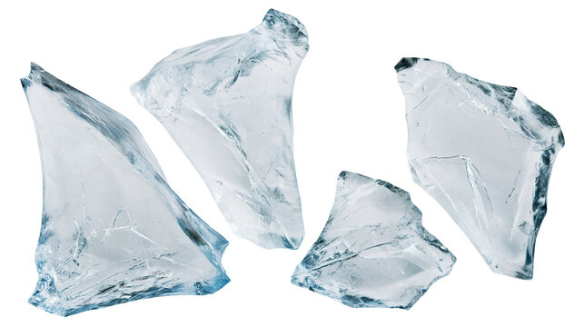 Isolated transparent fragments of broken ice or glass with cool blue tones and sharp edges