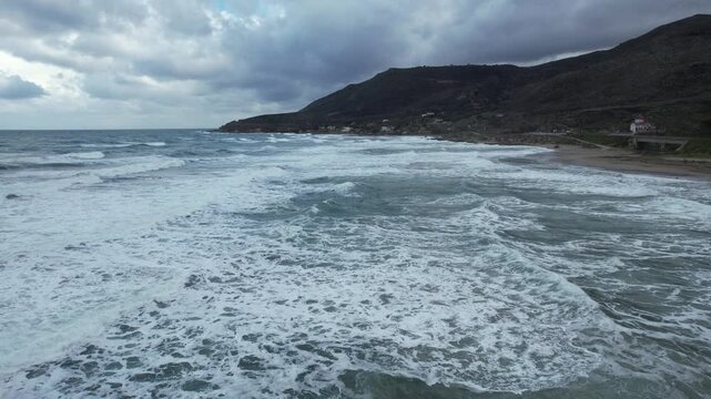 Rough sea waves along the coastline - aerial view - Crete