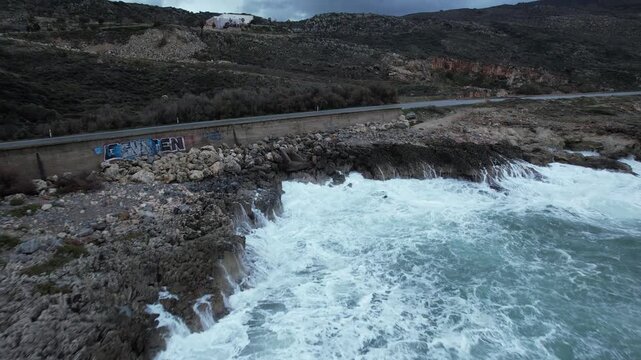 Waves crashing into a rocky inlet on a stormy day - Crete