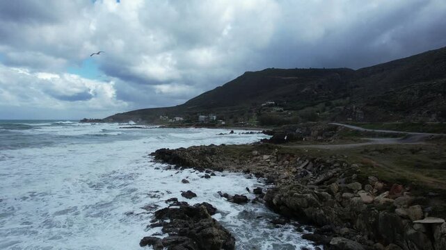 Waves breaking against a rocky headland - aerial view - Crete