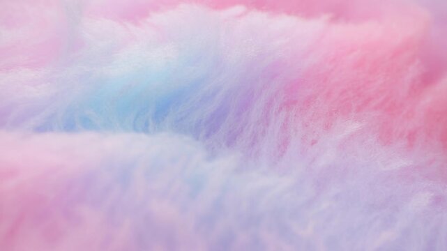 Slow motion close up of colorful fluffy fur fabric gently shifting across pastel surface in studio setting