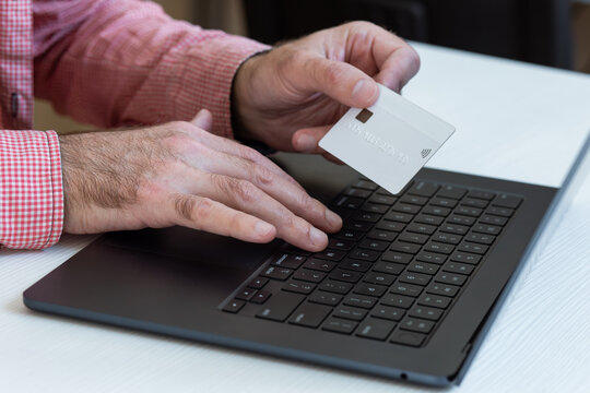 Placing an online pre-order using a credit card and a laptop.