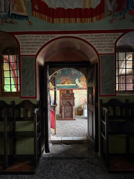 Ornate wooden door and Byzantine frescoes inside Greek Orthodox monastery