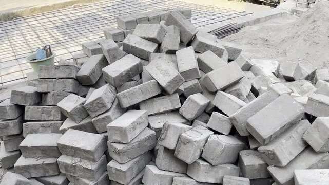 Pile of grey concrete paving blocks at construction site