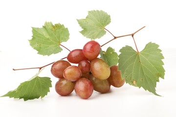 Fototapeta premium Bunch of fresh ripe grapes with green leaves on white background