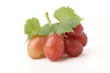Fototapeta premium Bunch of fresh ripe grapes with green leaves on white background