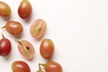 Fototapeta premium Fresh ripe grapes on white background, flat lay. Space for text