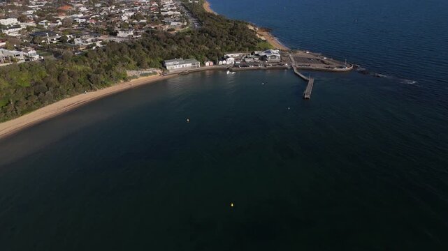 Panoramic aerial view of Black Rock Jetty, HMVS Cerberus breakwater, and coastline in Victoria Australia.