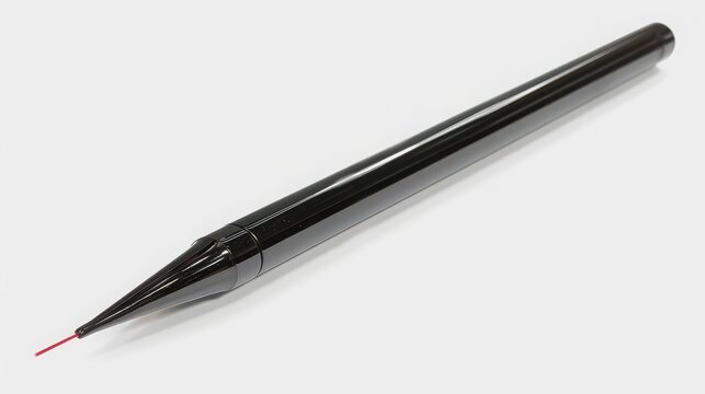 Laser pointer shaped like a sleek black pen emitting a thin red beam on a clean table.