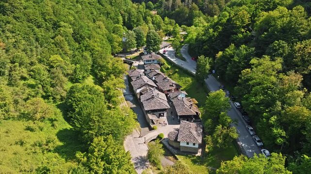 Etar open air ethnographic museum aerial top view traditional bulgarian stone houses surrounded lush green forest tourism landmark travel destination concept horizontal video stock footage