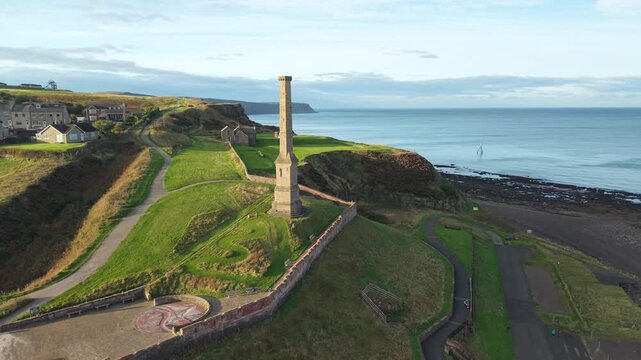 Aerial panoramic views of Whitehaven coastal town and civil parish. Town centre with architecture and main roads with moving vehicles in Sunrise, golden hour. Drone POV exploration of Devon County, UK