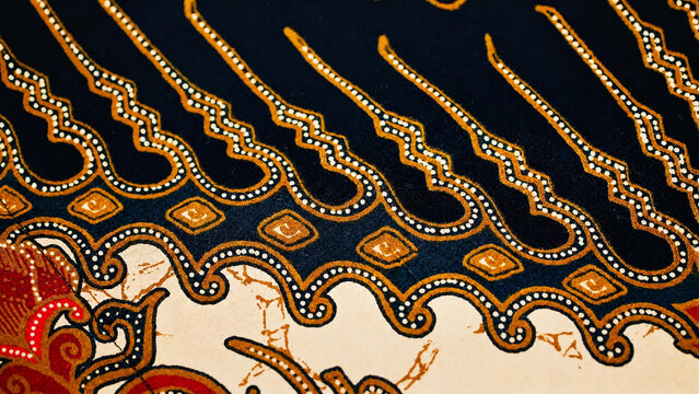 Texture of traditional Javanese soga batik fabric background with beautiful geometric pattern ornaments.