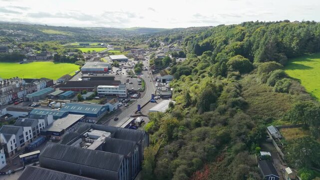 Aerial panoramic views of Whitehaven coastal town and civil parish. Town centre with architecture and main roads with moving vehicles in Sunrise, golden hour. Drone POV exploration of Devon County, UK