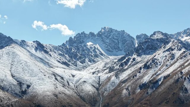 Cinematic 4K close up drone flyover showing detailed ice structure of glacier, fresh September snow on Issyk Bash peaks, dark green pine forest and mountain river near Akbulak in Tian Shan mountains