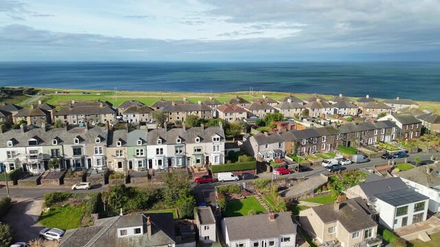 Aerial panoramic views of Whitehaven coastal town and civil parish. Demonstration of old Town architecture with roads and moving vehicles. Drone POV exploration of Devon County, England, UK.