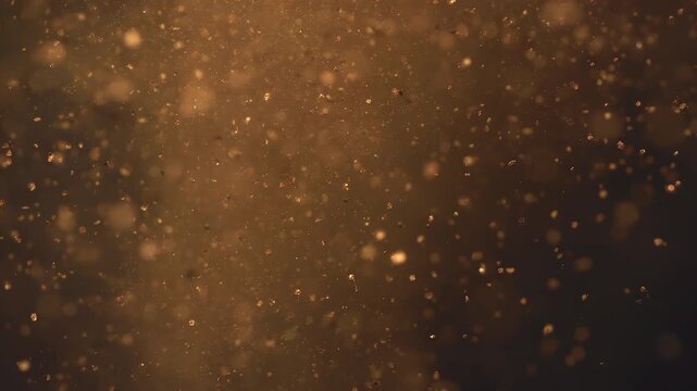 Golden makeup powder exploding in slow motion. Cosmetic glitter, beauty shimmer and luxury background