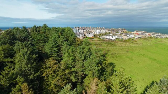 Aerial panoramic views of Whitehaven coastal town and civil parish. Demonstration of old Town architecture with roads and moving vehicles. Drone POV exploration of Devon County, England, UK.