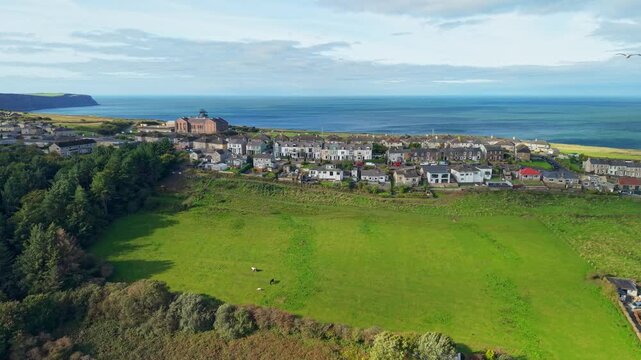 Aerial panoramic views of Whitehaven coastal town and civil parish. Demonstration of old Town architecture with roads and moving vehicles. Drone POV exploration of Devon County, England, UK.