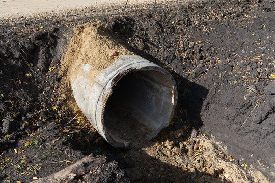 Concrete stormwater drainage pipe laid in an excavated trench at a construction site