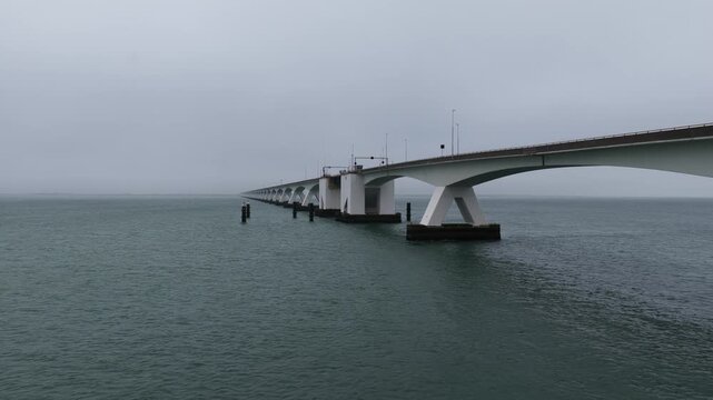 Zeeland bridge spanning oosterschelde water on a foggy day
