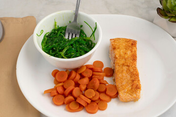 baked salmon  with  carrots and seaweed salad © dmiller324