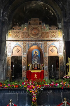 Decorated altar adorned with religious icons colorful flowers and ornate gold painted carvings including a carved wooden screen inside Sevanavank Monastery, Sevanavank, Armenia