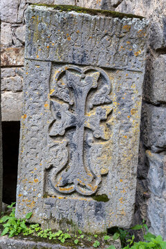 A close up detail highlights the intricate carving and ancient weathered pattern of an Armenian khachkar cross stone found at Tatev Monastery and its historic site, Tatev, Armenia