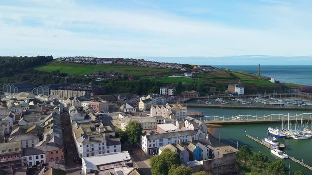 Aerial panoramic views of Whitehaven coastal town and civil parish. Demonstration of old Town architecture with roads and moving vehicles. Drone POV exploration of Devon County, England, UK.