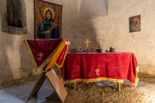 Close detailed view of the altar with its cross candle and sacred icon resting on a cloth covered table inside the historic Surb Hripsime church, Etchmiadzin, Armenia