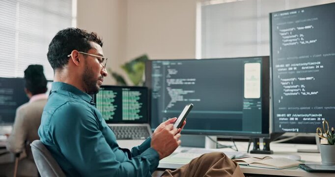 Programmer, texting and man with phone in office, software development or typing message on website. Programming, online and person with technology, coder and communication with contact on mobile app