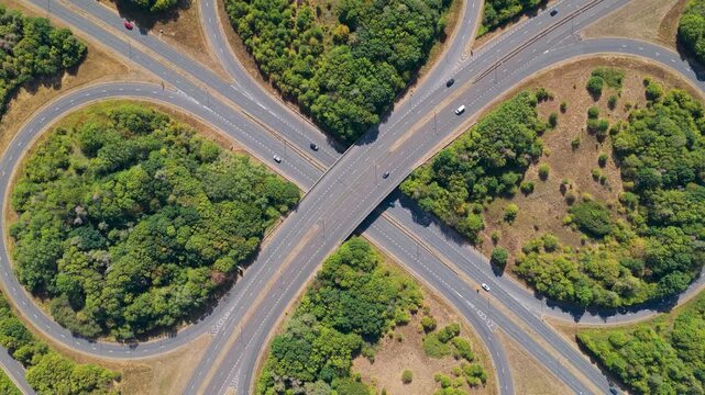 Aerial View of Vehicles Driving Along a Cloverleaf Highway