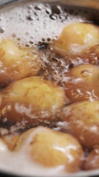 Boiling New Potatoes in Bubbling Water Close-Up Cooking Process Vertical Video