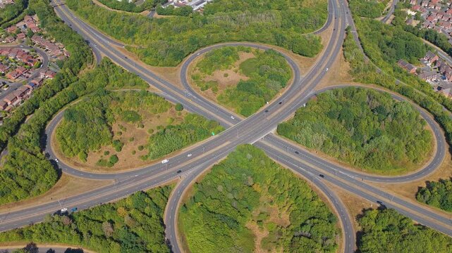 Aerial View of Cloverleaf Highway Interchange With Cars Moving
